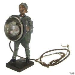 Lineol Signals soldier standing, with searchlight