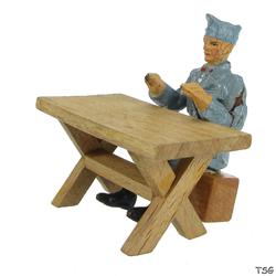 Elastolin Soldier sitting on box at table