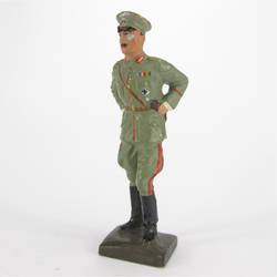 General standing, leaning over table