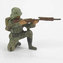 Soldier kneeling, shooting with rifle