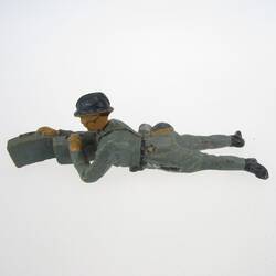 Soldier lying, with ammunition box