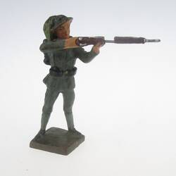 Soldier standing, shooting with rifle