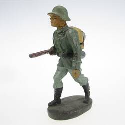 Soldier marching, bearing rifle under the arm