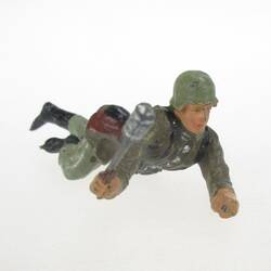 Soldier lying, with hand grenade